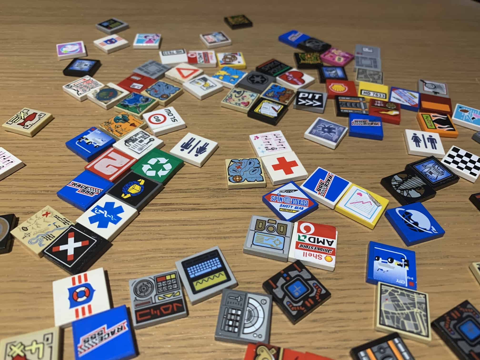 A pile of 2x2 tiles with prints and stickers